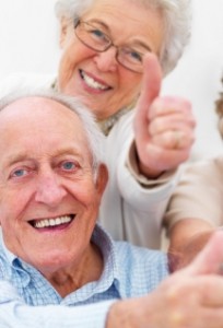 Group of older people showing thumbs up